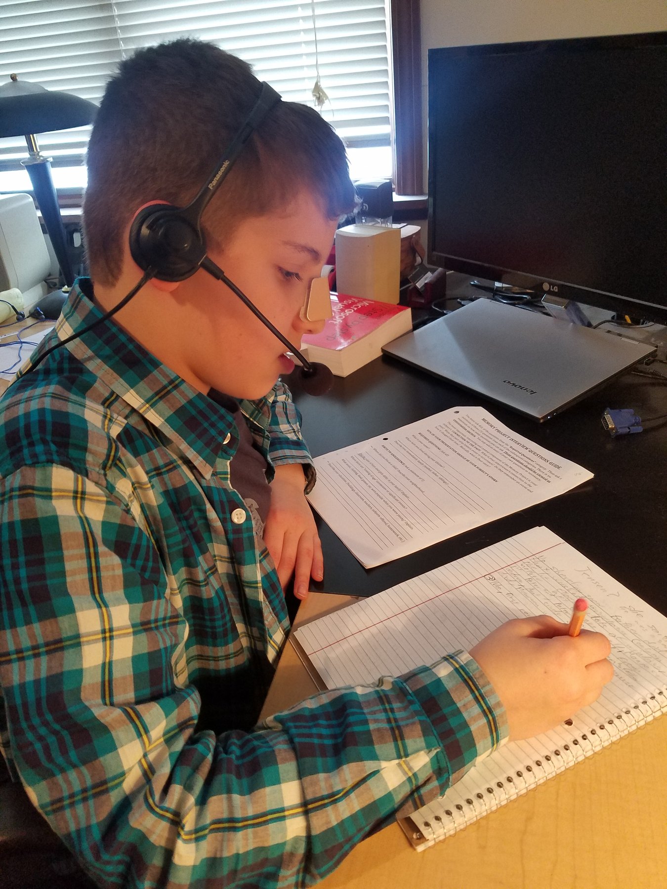 Judah taking notes on the Memory Project worksheet while listening to Grandma Shipton